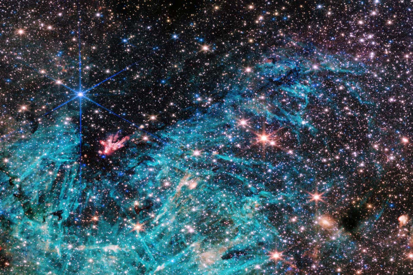 The NIRCam (Near-Infrared Camera) instrument on NASA?s James Webb Space Telescope?s reveals a portion of the Milky Way?s dense core in a new light. An estimated 500,000 stars shine in this image of the Sagittarius C (Sgr C) region, along with some as-yet unidentified features. A large region of ionized hydrogen, shown in cyan, contains intriguing needle-like structures that lack any uniform orientation. NASA, ESA, CSA, STScI, and S. Crowe (University of Virginia).
