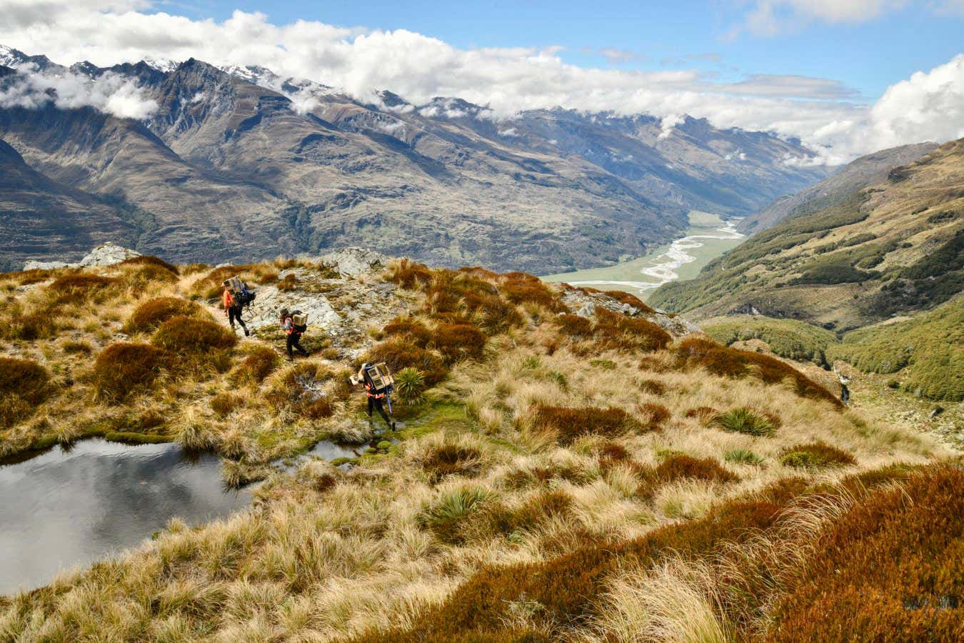 Southern Lakes Sanctuary field rangers install a line of stoat traps in the Kea Basin. Stoats are a particular threat to indigenous alpine species including Kea, Rock Wren as well as the endangered flightless Takahe which also spend time in alpine areas. Southern Lakes Sanctuary is a consortium of regional conservation groups involved in the suppression of predators that threaten New Zealand