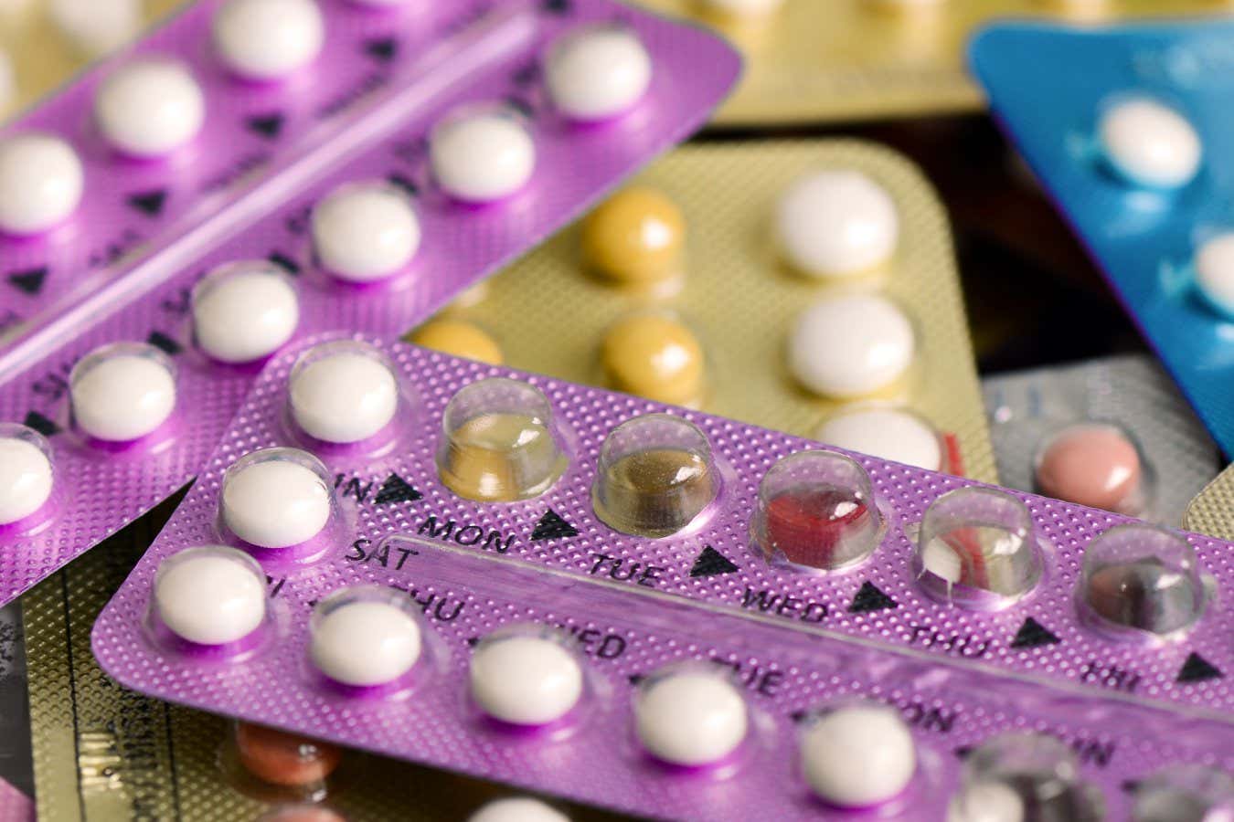 Oral contraceptive pill on pharmacy counter with colorful pills strips background.; Shutterstock ID 660070831; purchase_order: -; job: -; client: -; other: